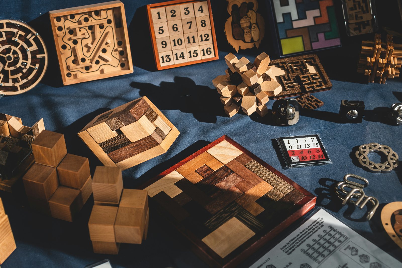 Wooden puzzles, number tiles and brain teasers laid out on a table